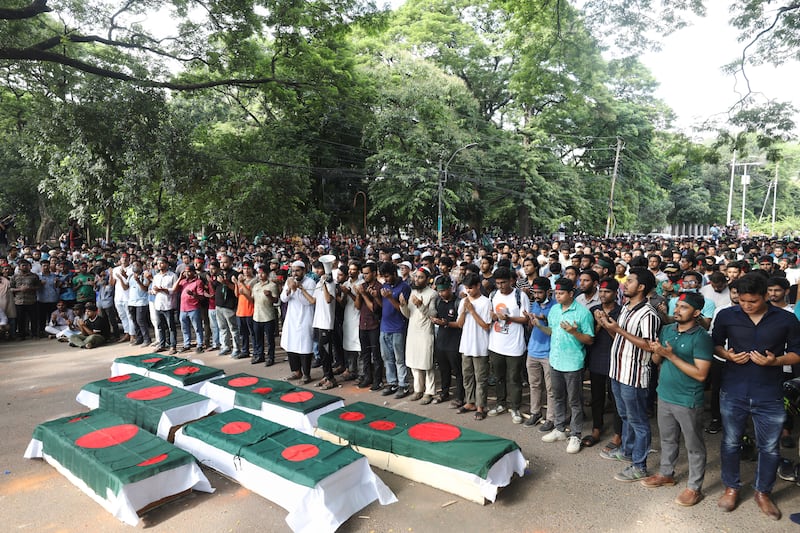 Students advocating for reform held a mock funeral at Dhaka University in memory of those who died during clashes on Wednesday (Rajib Dhar/AP)