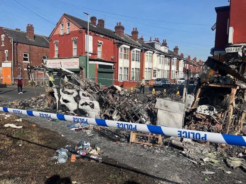 A burnt-out car in the Leeds suburb of Harehills