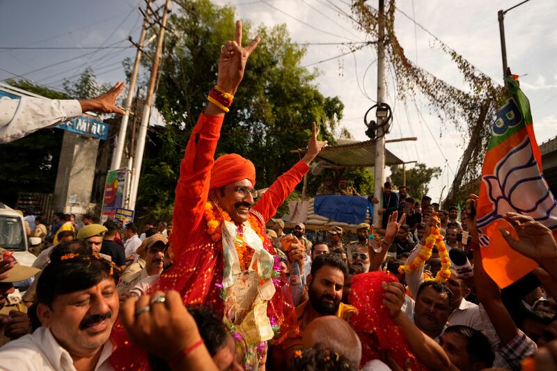 Bharatiya Janata Party (BJP) candidate Mohan Lal Bhagat greets supporters after his victory in Jammu, India (Channi Anand/AP)