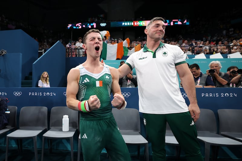 Rhys McClenaghan celebrates with coach Luke Carson after claiming Olympic gold at Bercy Arena on Saturday. Photo by Naomi Baker/Getty Images