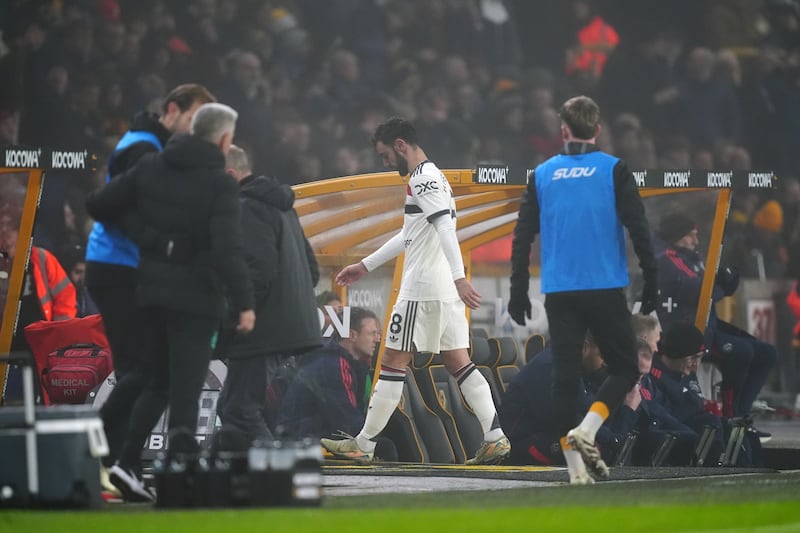 Bruno Fernandes (centre) heads down the tunnel after being sent off