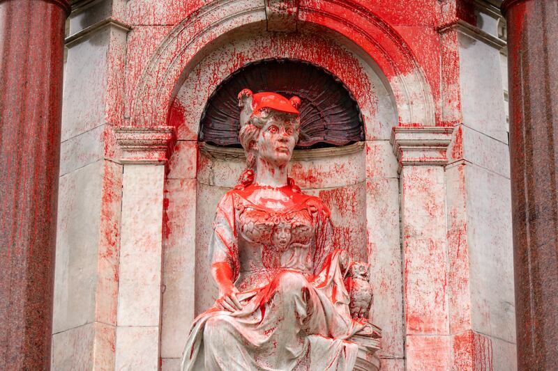 A Queen Victoria monument in Melbourne doused with red paint (Diego Fedele/AAP Image via AP)