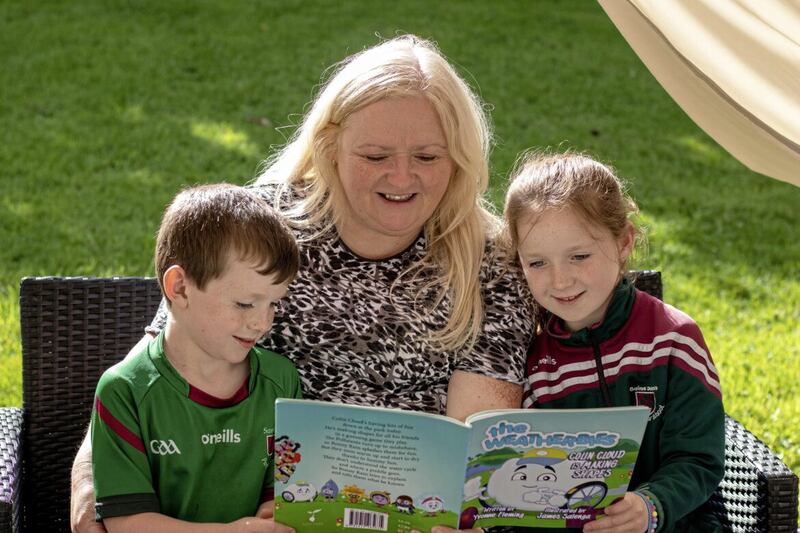 Yvonne Fleming reads one of her Weatherbies stories to her niece, Anna, and nephew, Danny. 