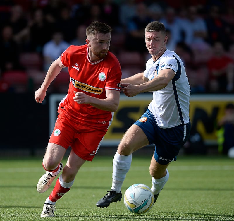 Cliftonville's Ronan Doherty takes on Jack Henderson of Portadown.