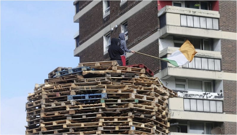 Two youths atop a bonfire in the New Lodge area of north Belfast 