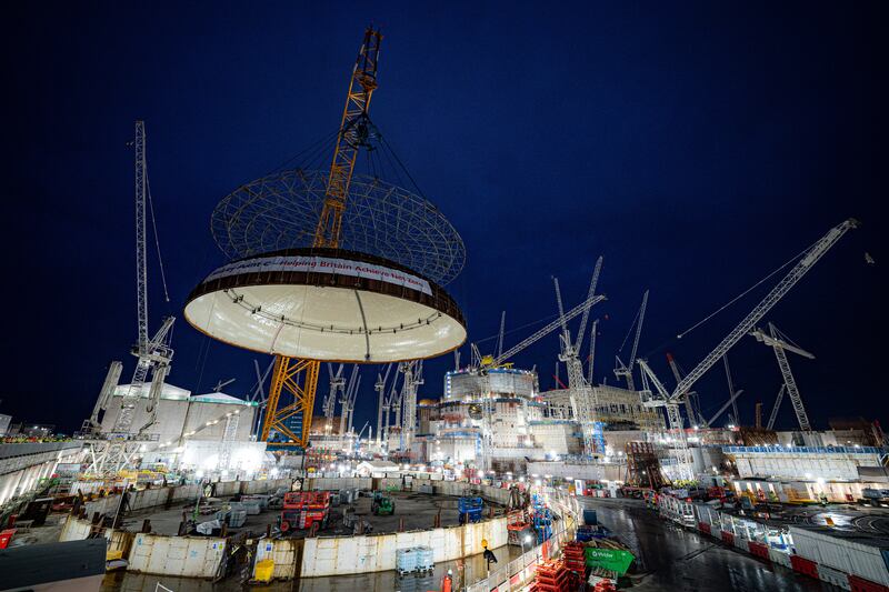 The steel dome being lifted onto Hinkley Point C’s first reactor building