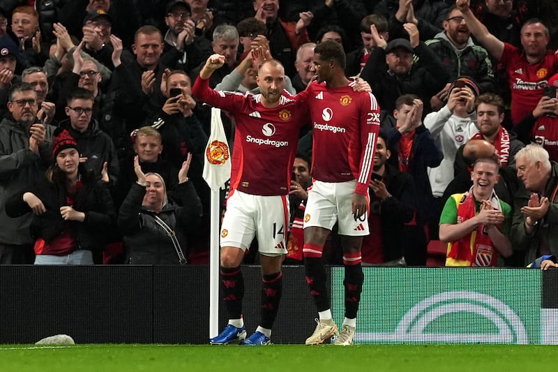 Christian Eriksen, left, celebrates his goal