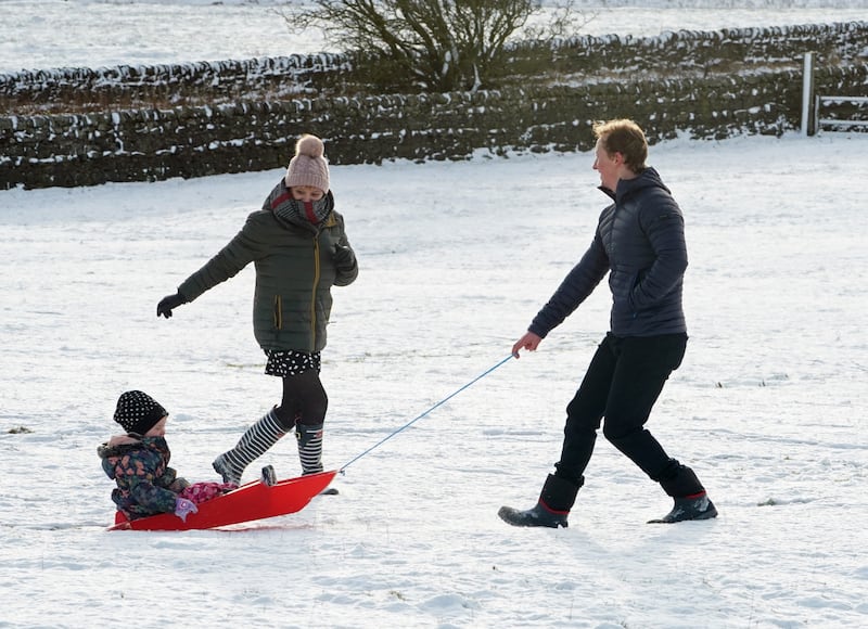 A family take advantage of Christmas Day snow with a trip out sledging on the hills near Hexham, Northumberland