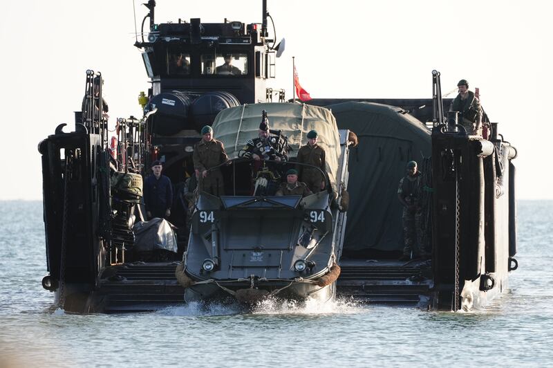 A military piper comes into shore on an amphibious vehicle in Arromanches in Normandy, France, to commemorate the 80th anniversary of the D-Day landings