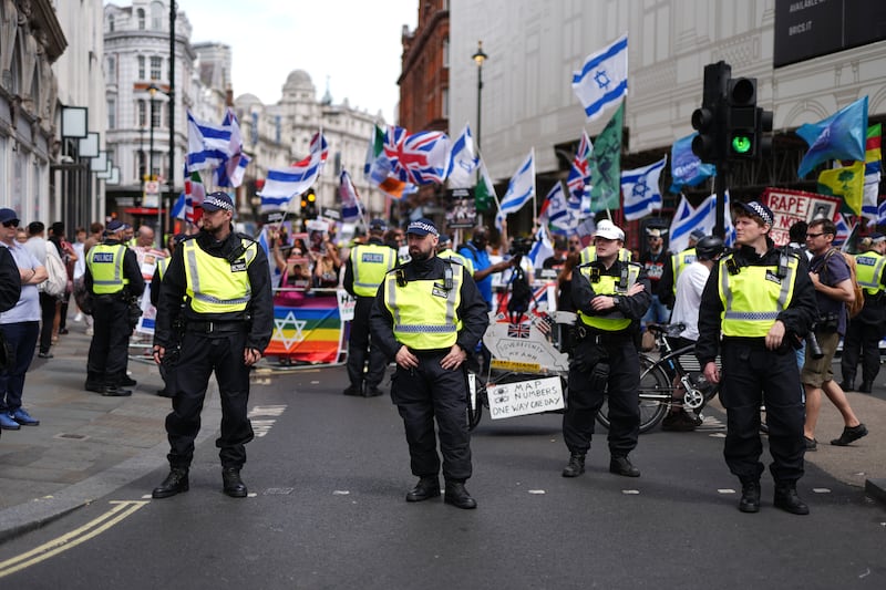 A heavy police presence as people take part in the Enough is Enough protest in Piccadilly Circus