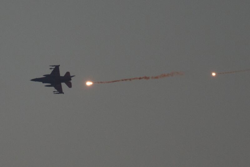 An Israeli fighter jet releases flares as it flies over the Gaza Strip on Tuesday (Leo Correa/AP)