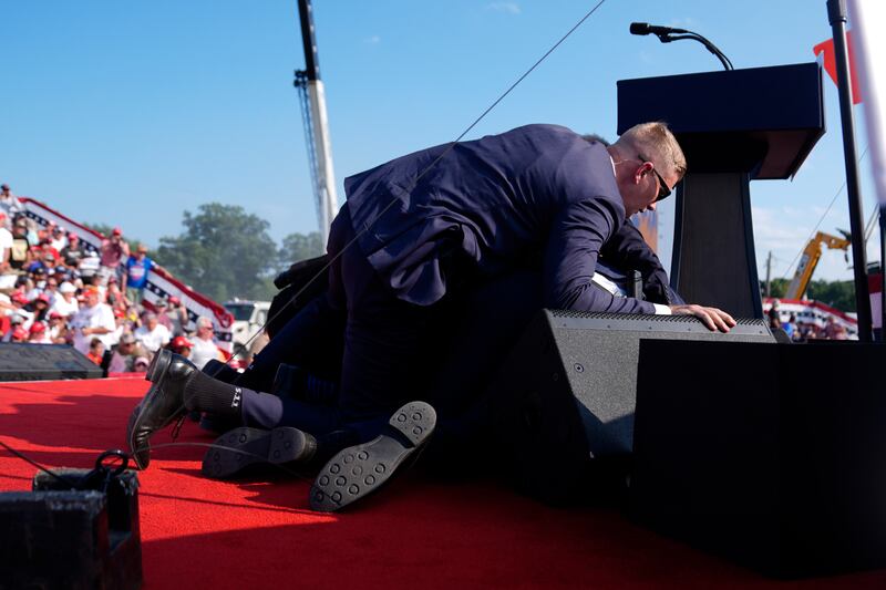 Republican presidential candidate former President Donald Trump is covered by US Secret Service agents (Evan Vucci/AP)