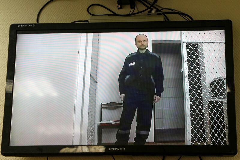 Opposition activist Vladimir Kara-Murza is seen on a TV screen during a video broadcast provided by the Russian Federal Penitentiary Service (Russian independent news outlet Sota telegram channel via AP)