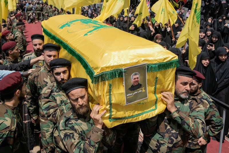 Hezbollah fighters have carried coffin of senior commander Taleb Sami Abdullah, known within Hezbollah as Hajj Abu Taleb (AP)