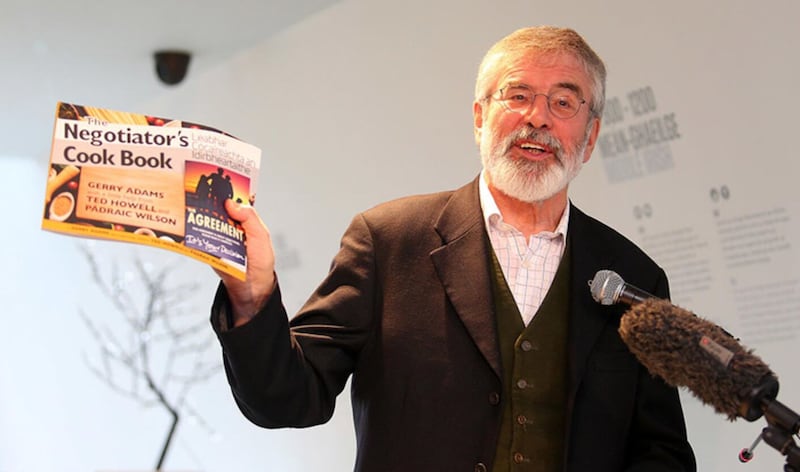 Gerry Adams with his Negotiator's Cook Book, which was written with the help of Ted Howell and published in 2018. PICTURE: MAL MCCANN