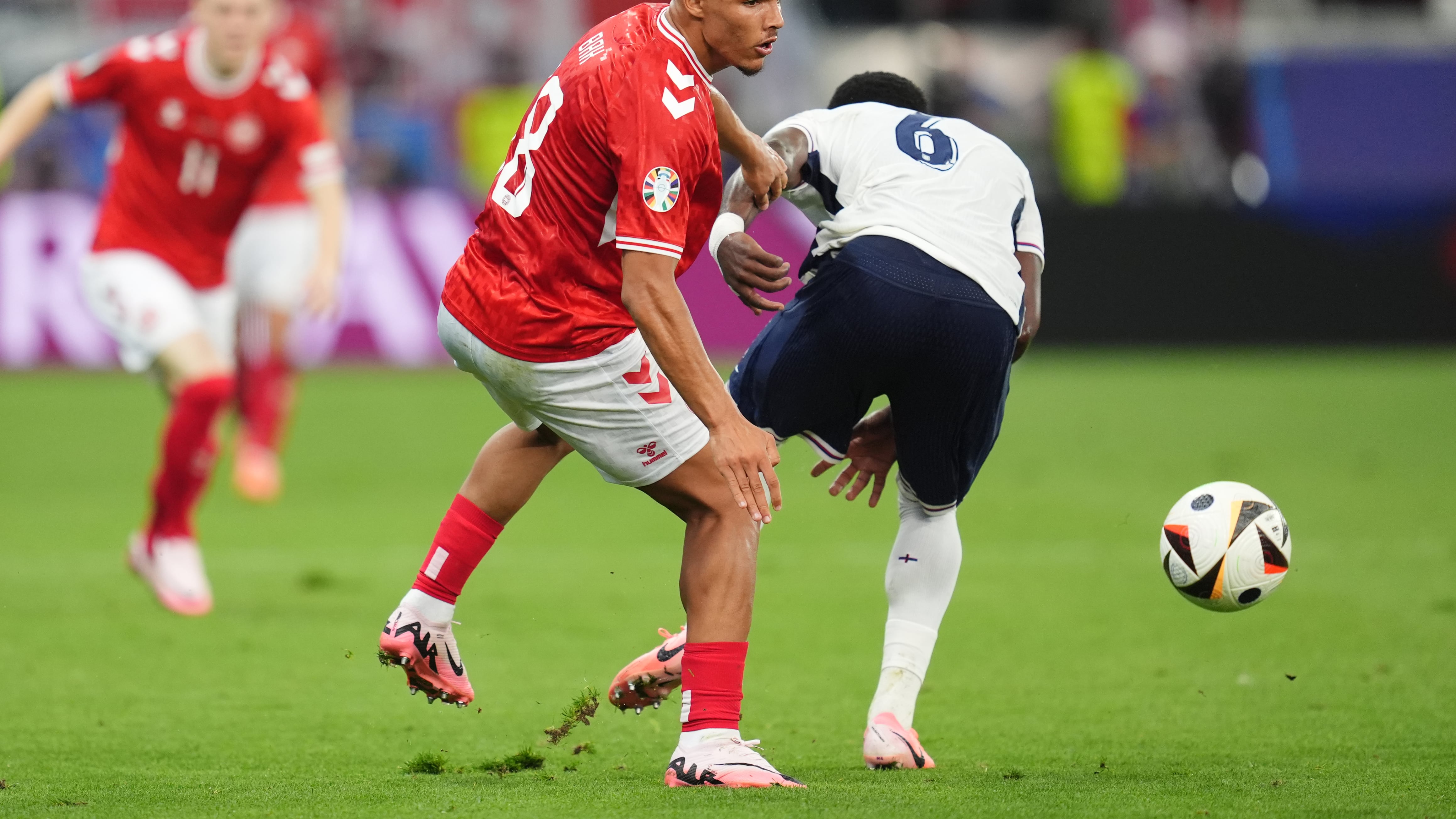 Denmark’s Alexander Bah and England’s Marc Guehi battle for the ball during the Euro 2024 match at the Frankfurt Arena