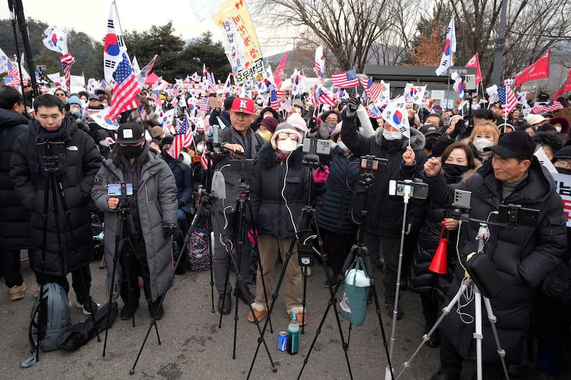 Supporters of Mr Yoon stage a rally to oppose his impeachment outside a detention centre in Uiwang, South Korea, on Thursday (Ahn Young-joon/AP)