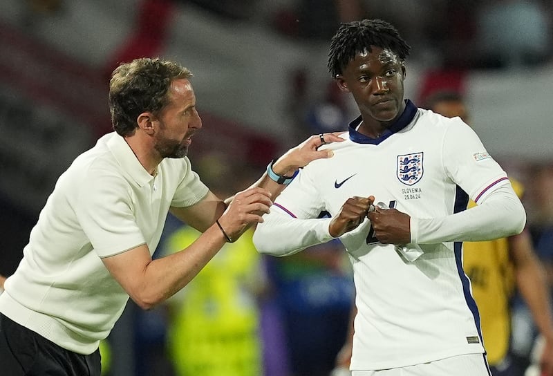 England manager Gareth Southgate, left, speaks to Kobbie Mainoo