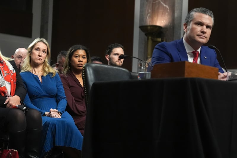 Jennifer Rauchet, left, listens as her husband Pete Hegseth, right, appears before the Senate Armed Services Committee (Jacquelyn Martin/AP)