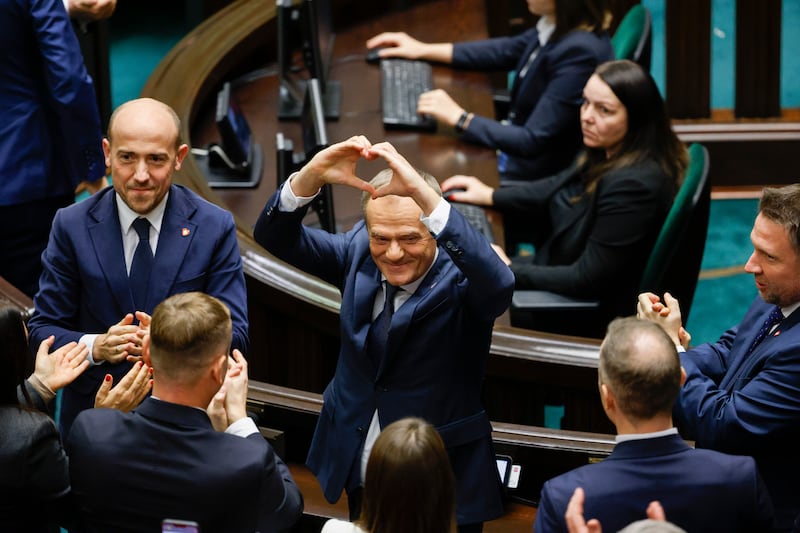 Donald Tusk celebrates in parliament in Warsaw after being elected Poland’s prime minister (Michal Dyjuk/AP)