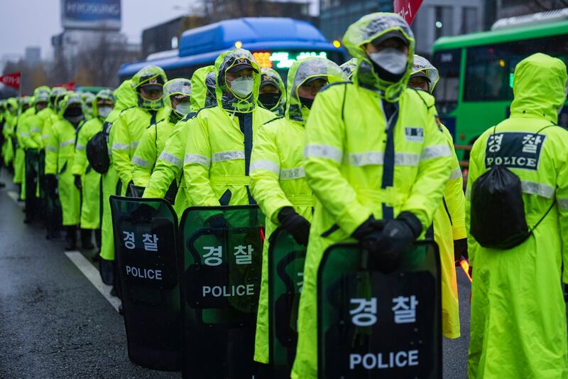 Police officers stand guard during a rally against South Korean President Yoon Suk Yeol (Lee Jin-man/AP)