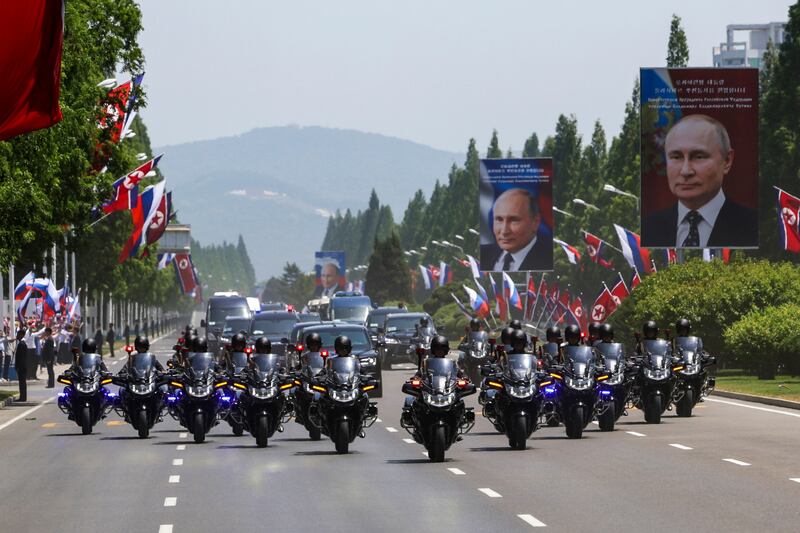 Mr Putin’s motorcade travels down a main boulevard in Pyongyang (Sputnik, Kremlin Pool Photo via AP)