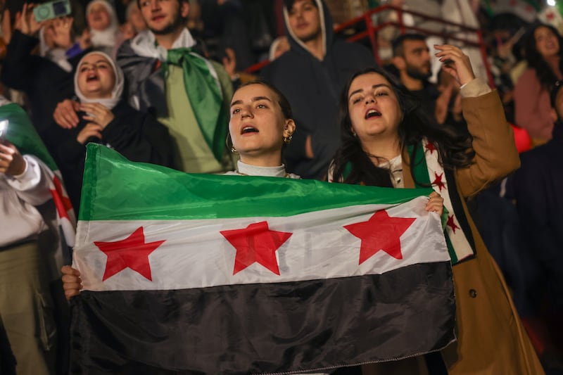 Young people wave flags at the concert (Ghaith Alsayed/AP)