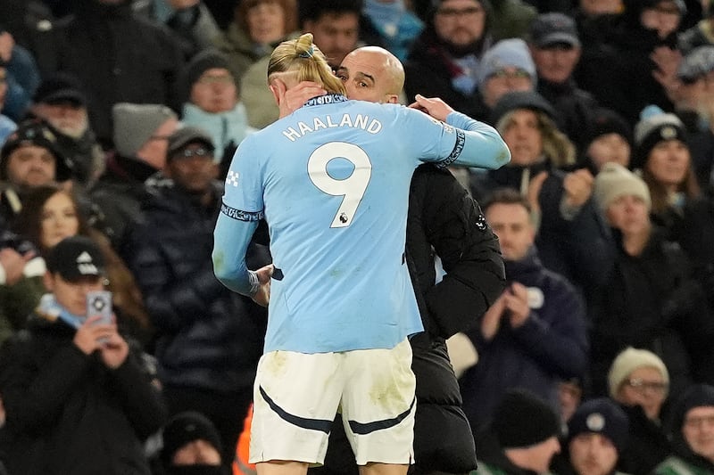 Manchester City manager Pep Guardiola, right, speaks to Erling Haaland