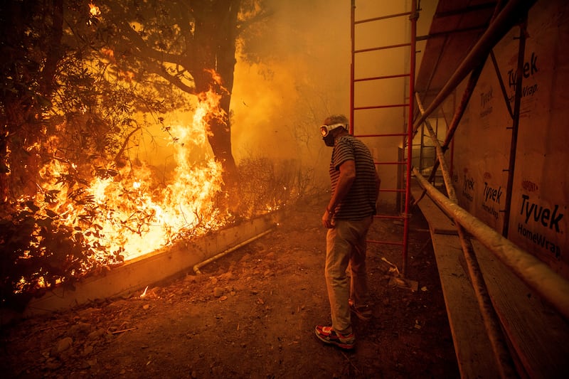 Tens of thousands of residents of LA have been ordered to evacuate as wildfires whip through the hillside (Ethan Swope/AP)