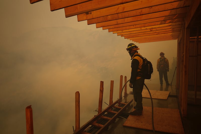 Firefighters monitor the advance of the Palisades Fire in Mandeville Canyon (Eric Thayer/AP)