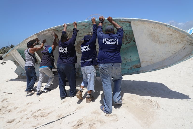 State employees relocate a boat for its protection ahead of the arrival of Hurricane Beryl in Progreso, Mexico (Martin Zetina/AP)