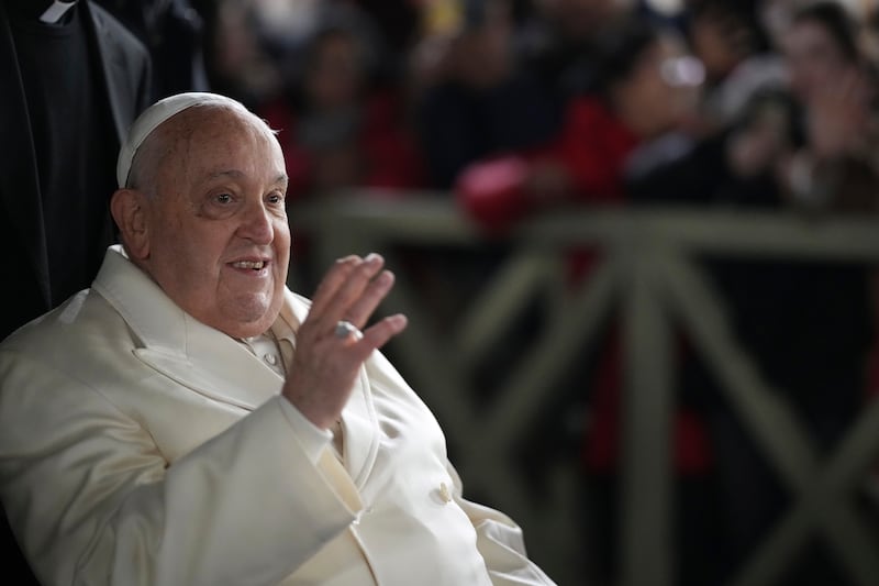 Pope Francis waves at worshippers congregated in St Peter’s Square after celebrating New Year’s Eve Vespers and Te Deum at the Vatican (Andrew Medichini/AP)