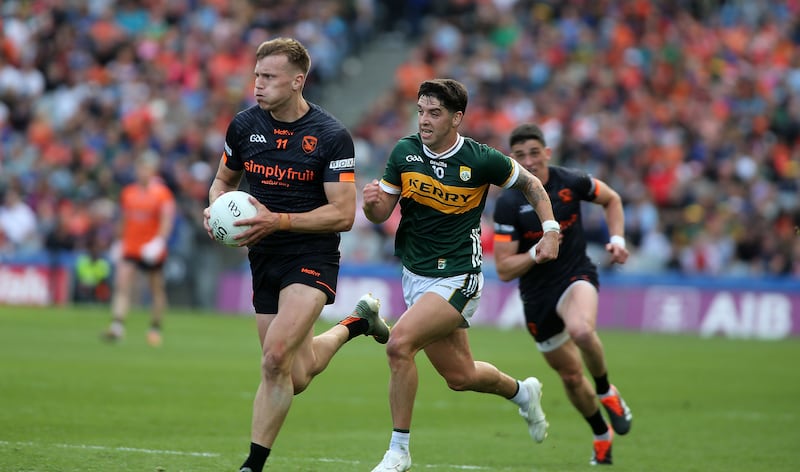 Rian O'Neill running past a Kerry player in the All-Ireland SFC semi-final