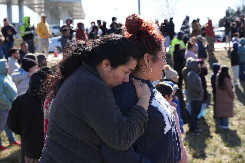 People wait as school buses arrive following a shooting at the Antioch High School in Nashville (George Walker IV/AP)