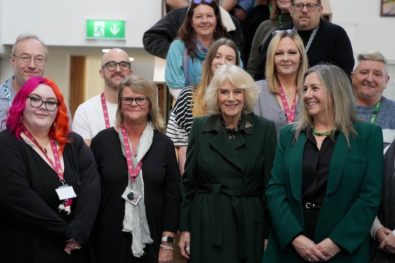 Queen Camilla poses with staff members during a visit to CoLab Exeter