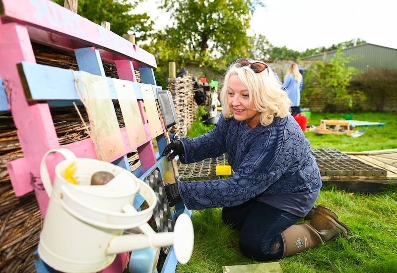 Lottery winner Maxine Tilbury helps spruce up a garden for toddlers at Sacrewell Farm in Peterborough.