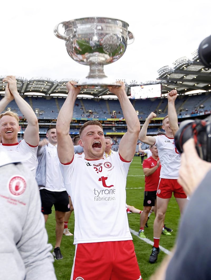 Niall Kelly lifts the Sam Maguire Cup aloft after Tyrone's triumph in September. <br />Pic Philip Walsh