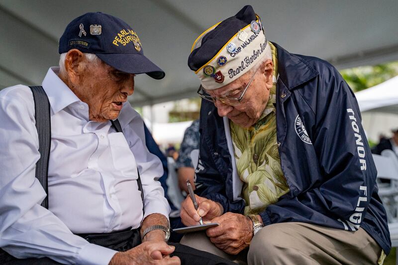 Harry Chandler, then 102, left, with fellow survivor Herb Elfring, 101, at the 82nd Pearl Harbour Remembrance Day ceremony in December 2023 (Mengshin Lin/AP)