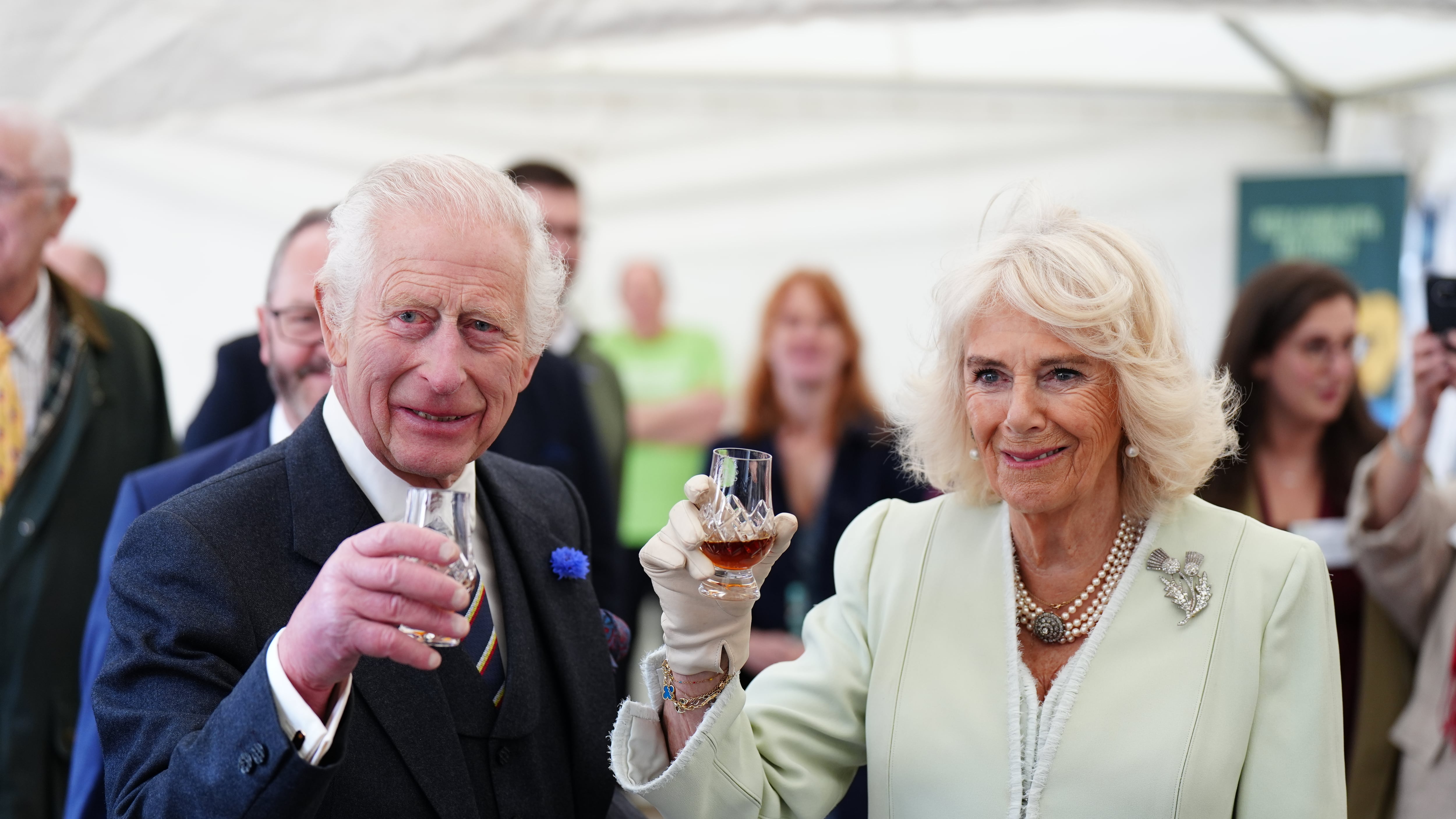 The King and Queen try a glass of whisky as they attend a celebration at Edinburgh Castle to mark the 900th anniversary of the City of Edinburgh