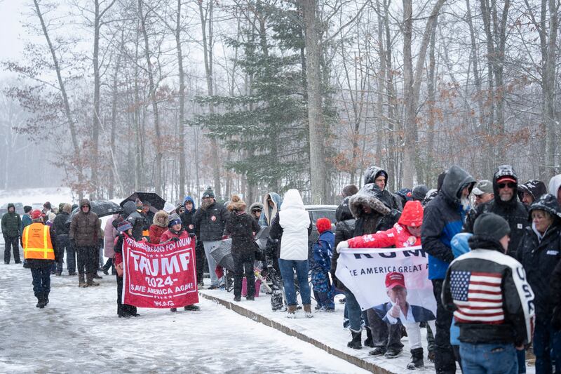 Donald Trump supporters queues during a winter snowstorm to enter a campaign event in Atkinson, NH, on Tuesday (Matt Rourke/AP)