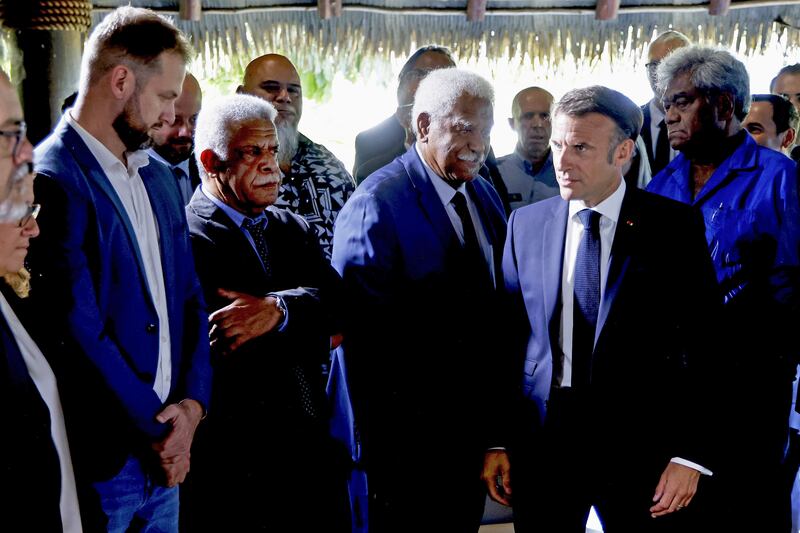 Mr Macron, second right, and New Caledonia’s president Louis Mapou, second left, during the visit (Ludovic Marin/Pool Photo via AP)