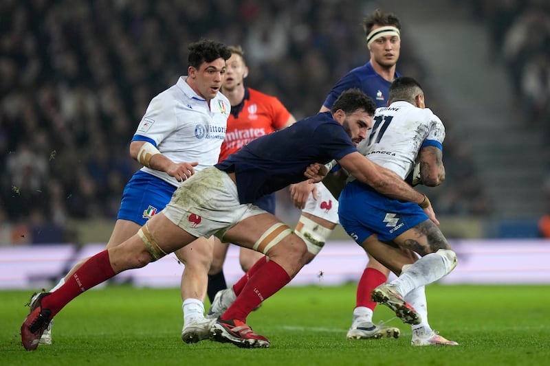 Charles Ollivon tackles Italy’s Montanna Ioane during the Six Nations match in Lille (Lewis Joly/AP)