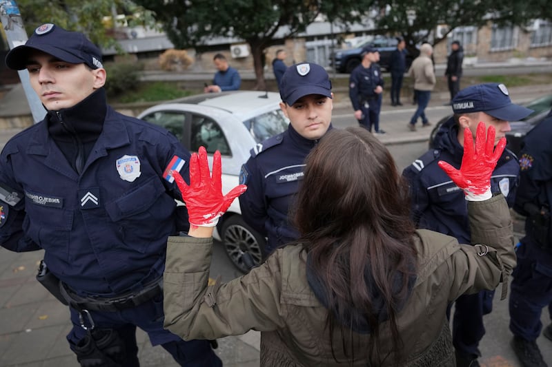 Protesters in Belgrade, with red paint on their hands to symbolise blood, shout slogans and demand arrests after the station disaster in Novi Sad on Friday (Darko Vojinovic/AP)