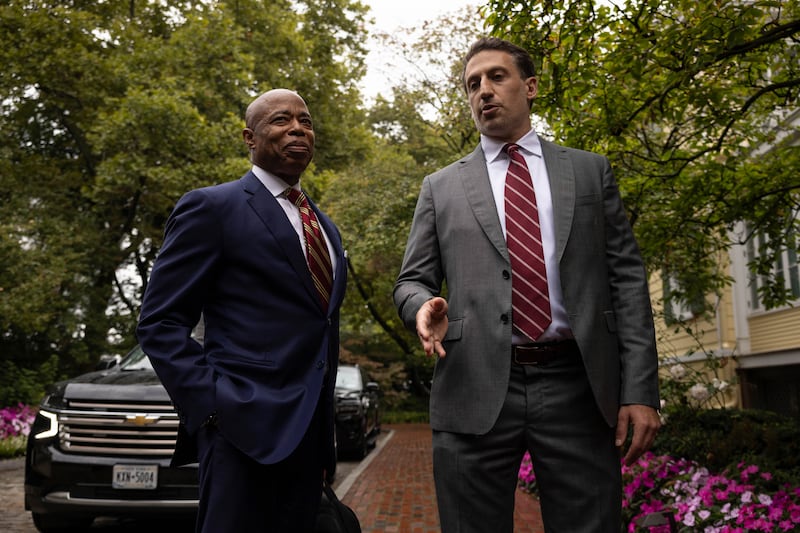 Eric Adams, left, and his lawyer Alex Spiro talk to members of the media as they exit Gracie Mansion, the official residence of the mayor, on Thursday in New York (Yuki Iwamura/AP)