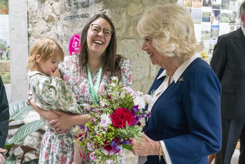 Camilla speaks to Romilly Bannerman, two, and her mother Violet Bannerman during a visit to the Gardening Bohemia exhibition at the Garden Museum, in Lambeth, south London