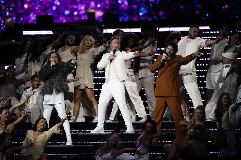 Mark Owen, Gary Barlow and Howard Donald from Take That performing on stage at BST Hyde Park in London (Jordan Pettitt/PA)