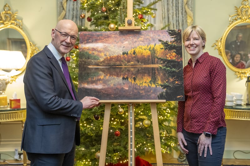 John Swinney and PA news agency photographer Jane Barlow at the launch of the First Minister’s official Christmas card