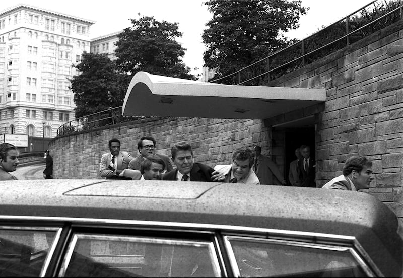 President Ronald Reagan is pushed into his limousine by Secret Service agents after being shot outside a Washington hotel in March 1981 (Ron Edmonds/AP)