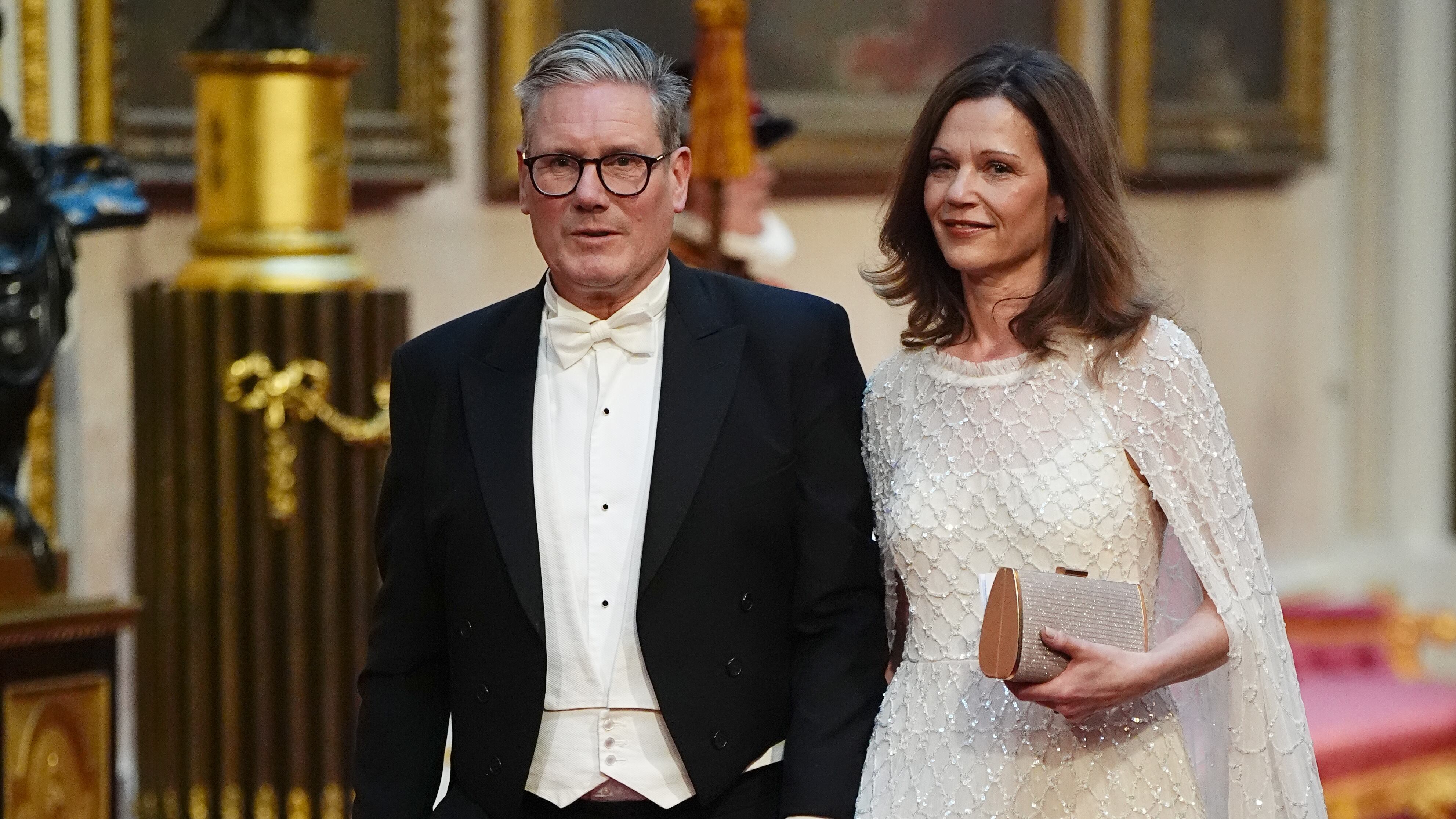 Labour leader Sir Keir Starmer and his wife Victoria make their way along the East Gallery to attend the state banquet for Emperor Naruhito and his wife Empress Masako of Japan at Buckingham Palace