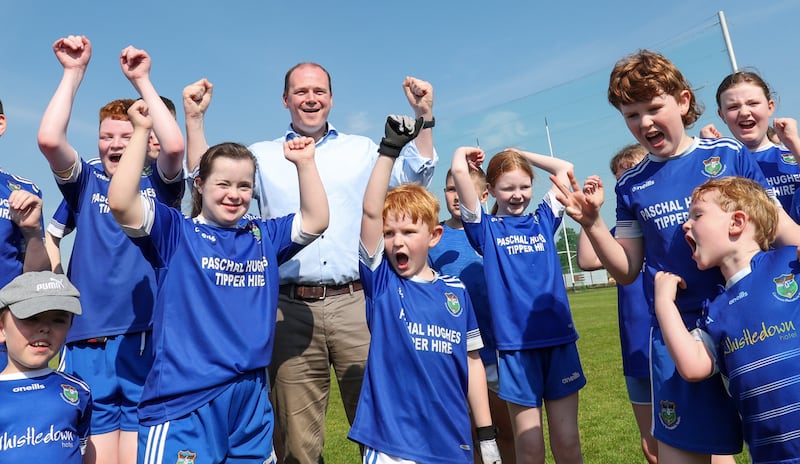 Sports Minister Gordon  Lyons with players from Warrenpoint  during an GAA event at Kickham's GAC Creggan on Saturday.
PICTURE COLM LENAGHAN